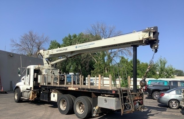 Pluma National Crane 600E2 y camión Kenworth T440 vistos desde el costado