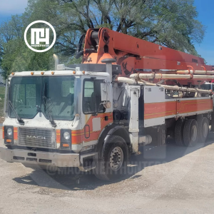 Bomba de concreto Schwing 39 metros montada sobre camión MACK vista lateral delantera.